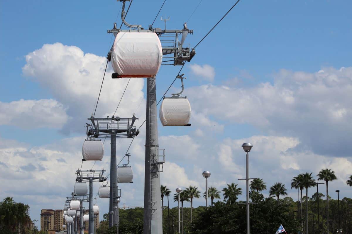 disney skyliner gondolas designs beneath tarps full capacity