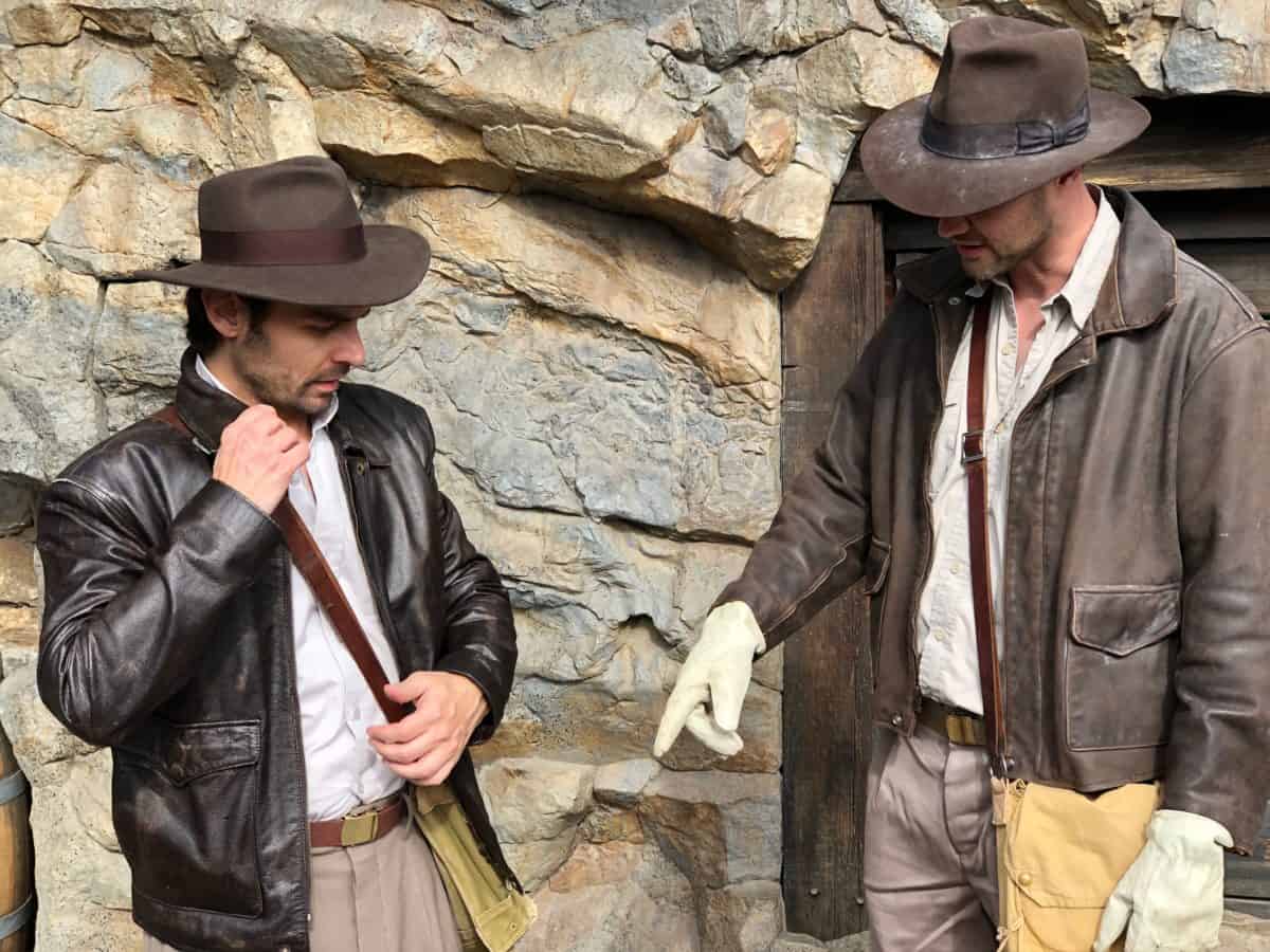 A pair of Adventurelanders compare costume notes to help them keep up with the Joneses.
