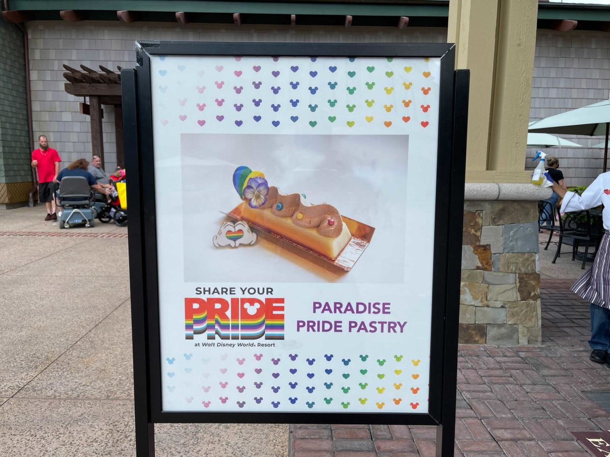 A sign advertising the new Paradise Pride Pastry available for Pride Month at Amorette's Patisserie in Disney Springs at Walt Disney World