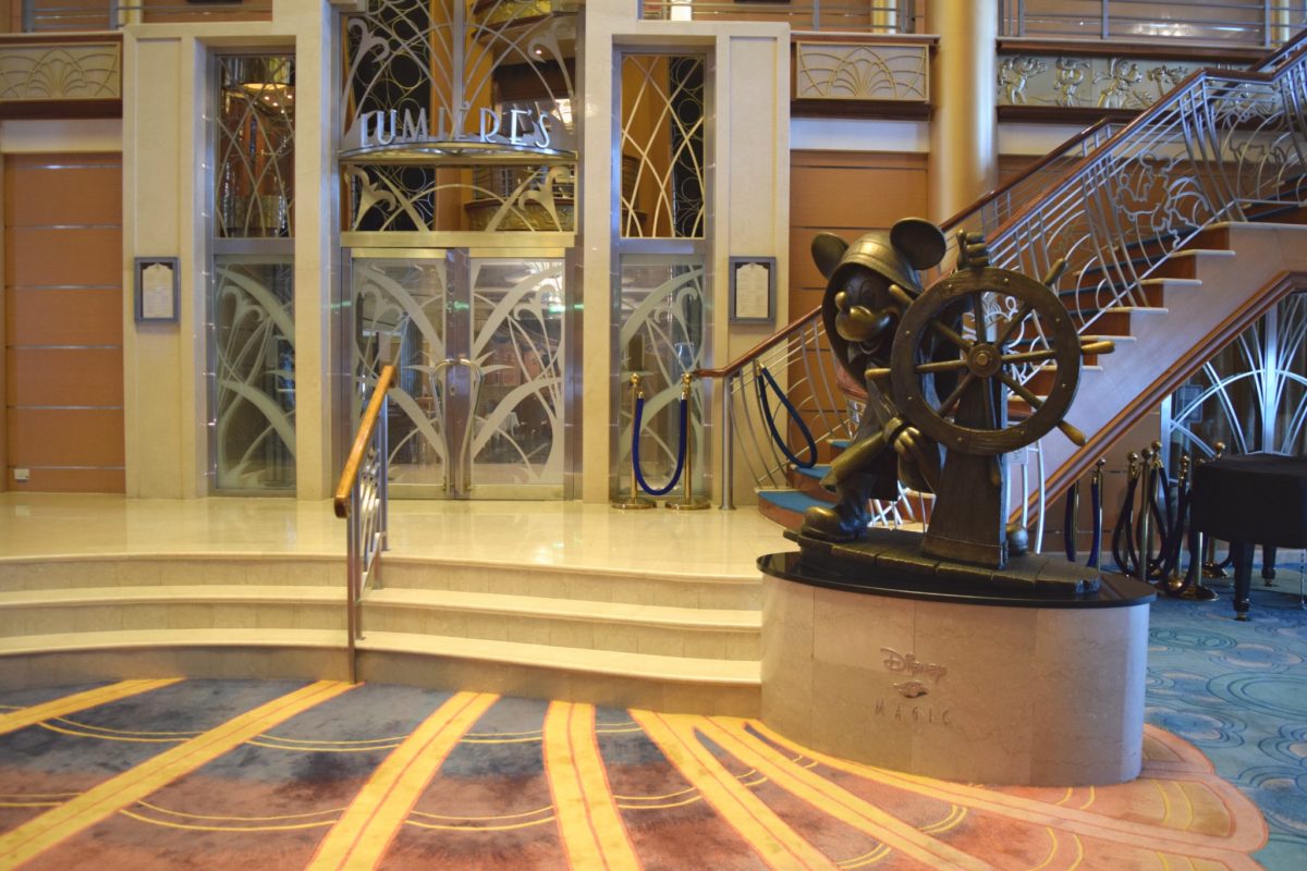 Captain Mickey statue and Lumiere's entrance in Disney Magic atrium