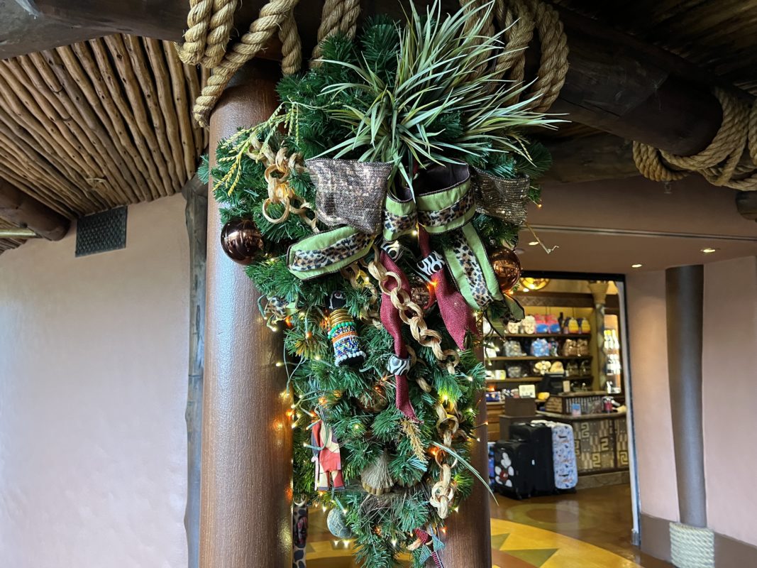 Garland on either side of the lobby on the posts disney animal kingdom lodge 2022 holidays 2