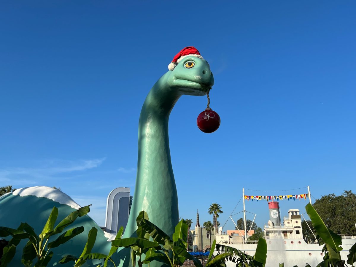Gertie the dinosaur in Santa hat with ornament