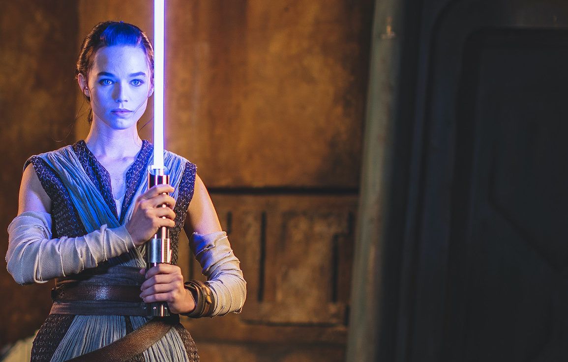 Rey with a blue lightsaber on Star Wars: Galactic Starcruiser