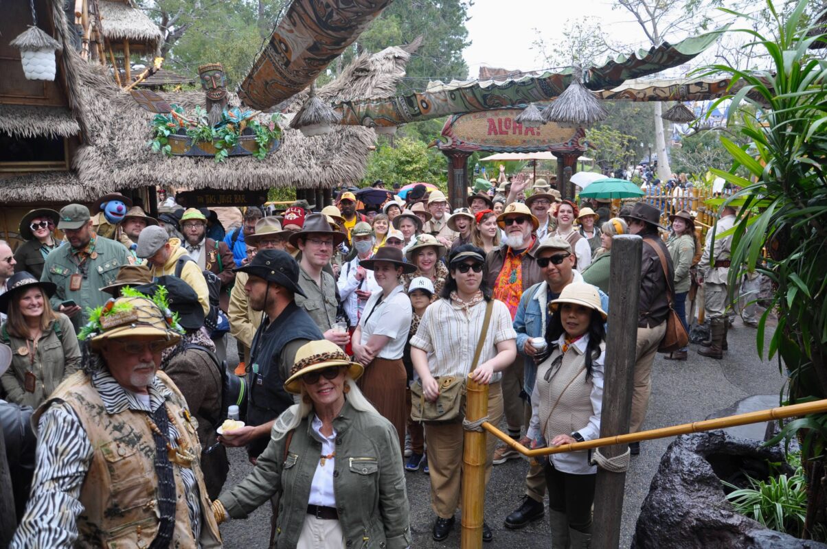 Guests attending Adventureland Day at Disneyland gather outside the Enchanted Tiki Room.