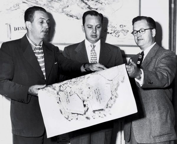 In a July 1953 photo, Walt Disney, executive C.V. Wood, Jr. and Harrison "Buzz" Price, from left, look over plans for what would eventually become Disneyland. Price was an engineer turned theme-park strategist whose research led Walt Disney to locate Disney's theme parks in Anaheim and Orlando.